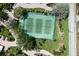 Aerial view of well-maintained community tennis courts surrounded by lush landscaping at 8735 Midnight Pass Rd # 602B, Sarasota, FL 34242
