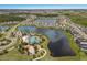 Aerial view of the community amenities including the pool, clubhouse, playground, and surrounding lakes at 8985 Royal River Cir, Parrish, FL 34219