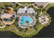 Aerial of community pool and clubhouse with sunshades, playground, and lake at 8985 Royal River Cir, Parrish, FL 34219