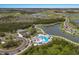 Stunning aerial view of community pool, amenity center, and surrounding landscape with lakes and homes at 8985 Royal River Cir, Parrish, FL 34219