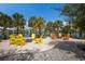 Beautifully landscaped community space with seating around fire pits and views of the water in Florida at 8985 Royal River Cir, Parrish, FL 34219