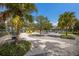 Scenic view of a community amenity space with comfortable seating under palm trees near the water in Florida at 8985 Royal River Cir, Parrish, FL 34219