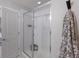 A modern bathroom showcases a sleek glass-enclosed shower with white subway tile and a neutral color palette at 8985 Royal River Cir, Parrish, FL 34219