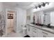A bright bathroom features a double vanity, toilet, and a walk-in closet for optimal storage and convenience at 8985 Royal River Cir, Parrish, FL 34219