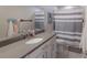 Bathroom with vanity, mirror, towels, and a striped shower curtain at 8985 Royal River Cir, Parrish, FL 34219