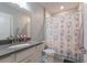 Well-lit bathroom featuring a modern vanity, a toilet, and a fun shower curtain at 8985 Royal River Cir, Parrish, FL 34219