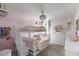 Whimsical pink bedroom with a bunk bed, ladder, and a chandelier at 8985 Royal River Cir, Parrish, FL 34219
