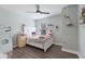 Charming bedroom with a white bed, playful decor, and a ceiling fan at 8985 Royal River Cir, Parrish, FL 34219