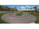 A looped bike track surrounded by grass and landscaping provides an outdoor activity within the community at 8985 Royal River Cir, Parrish, FL 34219