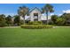 The Brightwood Pavilion clubhouse features a modern exterior design, lush green landscaping, and lots of natural light at 8985 Royal River Cir, Parrish, FL 34219
