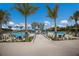 Resort-style community pool featuring a waterslide, seating, and lush landscaping in Florida at 8985 Royal River Cir, Parrish, FL 34219