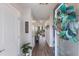 Inviting entryway with wood-look flooring, a welcome sign, and a view of the living area at 8985 Royal River Cir, Parrish, FL 34219