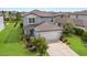 This inviting two-story home boasts a well-manicured lawn, attached garage, and charming front entry at 8985 Royal River Cir, Parrish, FL 34219