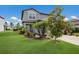 Charming two-story home featuring a well-manicured lawn and beautiful, colorful landscaping at 8985 Royal River Cir, Parrish, FL 34219