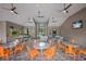 A well-lit community game room with a ping pong table, a pool table, several tables and chairs, and a flat screen TV at 8985 Royal River Cir, Parrish, FL 34219