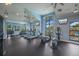 A well-equipped community gym with treadmills, elliptical machines, and large windows offering beautiful outdoor views at 8985 Royal River Cir, Parrish, FL 34219