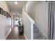 Hallway featuring wood-look flooring, staircase, and view of the entryway with front door at 8985 Royal River Cir, Parrish, FL 34219