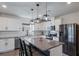 Modern kitchen features stainless steel appliances, a central island with seating, and white cabinets at 8985 Royal River Cir, Parrish, FL 34219