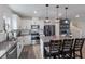 Modern kitchen features stainless steel appliances, a central island with seating, and white cabinets at 8985 Royal River Cir, Parrish, FL 34219