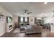 Open concept living area with a fireplace, large sectional, and dining area, with hardwood floors at 8985 Royal River Cir, Parrish, FL 34219