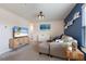 Cozy living room with a plush sofa, stylish TV stand, and accent wall at 8985 Royal River Cir, Parrish, FL 34219