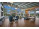 Spacious resident lounge with modern seating, a high ceiling, and expansive windows showcasing outdoor views at 8985 Royal River Cir, Parrish, FL 34219