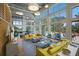 Bright and airy lounge area with high ceilings, large windows, and comfortable contemporary furnishings at 8985 Royal River Cir, Parrish, FL 34219