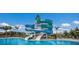 Exciting community pool with a large, colorful waterslide, surrounded by lounge chairs, in Florida at 8985 Royal River Cir, Parrish, FL 34219