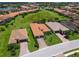 Aerial view of the home's community featuring green lawns, tile roofs, and well-manicured landscaping at 10120 Carnoustie Pl, Bradenton, FL 34211