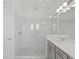 Elegant bathroom with white subway tiles, gray cabinets, and a glass-enclosed shower at 10120 Carnoustie Pl, Bradenton, FL 34211