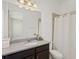 Stylish bathroom with a large mirror, vanity with dark cabinets, and shower with a shower curtain at 10120 Carnoustie Pl, Bradenton, FL 34211