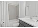 Bright bathroom featuring a tub/shower combo, gray tile, and a modern vanity at 10120 Carnoustie Pl, Bradenton, FL 34211