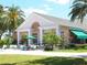 Clubhouse exterior with shaded seating and lush landscaping at 10120 Carnoustie Pl, Bradenton, FL 34211