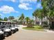 Clubhouse exterior with golf carts parked outside and mature landscaping at 10120 Carnoustie Pl, Bradenton, FL 34211