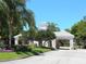 Community entrance with a guard house, manicured landscaping, and a paved entranceway at 10120 Carnoustie Pl, Bradenton, FL 34211