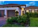 Close-up of the exterior showcasing a well-manicured lawn and decorative front garden at 10120 Carnoustie Pl, Bradenton, FL 34211