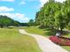 Scenic view of the golf course with a paved pathway and lush landscaping at 10120 Carnoustie Pl, Bradenton, FL 34211
