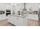 Modern kitchen with stainless steel appliances, granite countertops, and a stylish tile backsplash at 10120 Carnoustie Pl, Bradenton, FL 34211