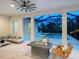 Inviting indoor/outdoor living space with a fireplace and views of the pool and backyard at 10120 Carnoustie Pl, Bradenton, FL 34211