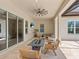 Relaxing covered patio with a fire pit, seating, and a mounted television at 10120 Carnoustie Pl, Bradenton, FL 34211