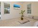 Relaxing covered patio with a sofa, ceiling fan, and a wall-mounted television at 10120 Carnoustie Pl, Bradenton, FL 34211