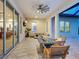 Extended covered patio featuring a fire pit, TV, fan, and outdoor lounge seating at 10120 Carnoustie Pl, Bradenton, FL 34211