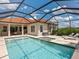 Inviting pool with a jacuzzi and a screened-in lanai, offering privacy and comfort at 10120 Carnoustie Pl, Bradenton, FL 34211