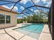 Beautiful pool area with a screened enclosure and landscaped surroundings at 10120 Carnoustie Pl, Bradenton, FL 34211