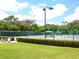 Well-maintained tennis courts surrounded by lush landscaping and greenery, perfect for recreational play at 10120 Carnoustie Pl, Bradenton, FL 34211