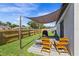 Backyard featuring a covered patio with outdoor seating, a grill, and a well-maintained green lawn at 1107 22Nd E St, Palmetto, FL 34221