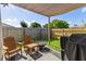 Cozy backyard patio featuring a fire pit, Adirondack chairs, and shade covering, perfect for outdoor relaxation at 1107 22Nd E St, Palmetto, FL 34221