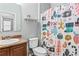Cozy bathroom featuring a vanity sink, toilet, and a festive holiday-themed shower curtain at 1107 22Nd E St, Palmetto, FL 34221