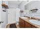 Bright bathroom featuring double vanity sinks, wood cabinets, and a shower with white shower curtain at 1107 22Nd E St, Palmetto, FL 34221