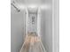 Well-lit hallway with light-colored walls and wood-look flooring, connecting various rooms in the home at 1107 22Nd E St, Palmetto, FL 34221
